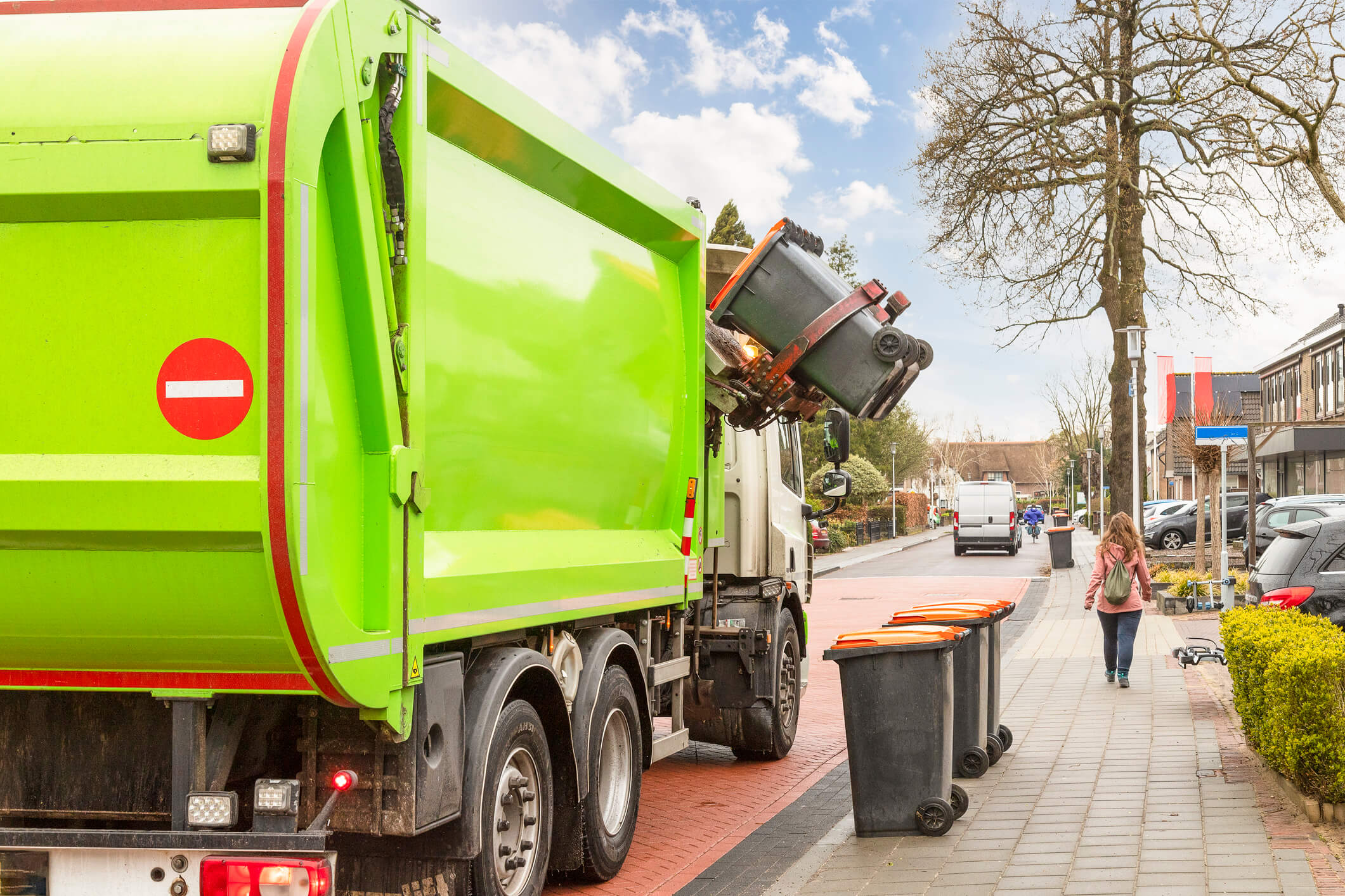 Recycling truck picks up commercial bins on city street